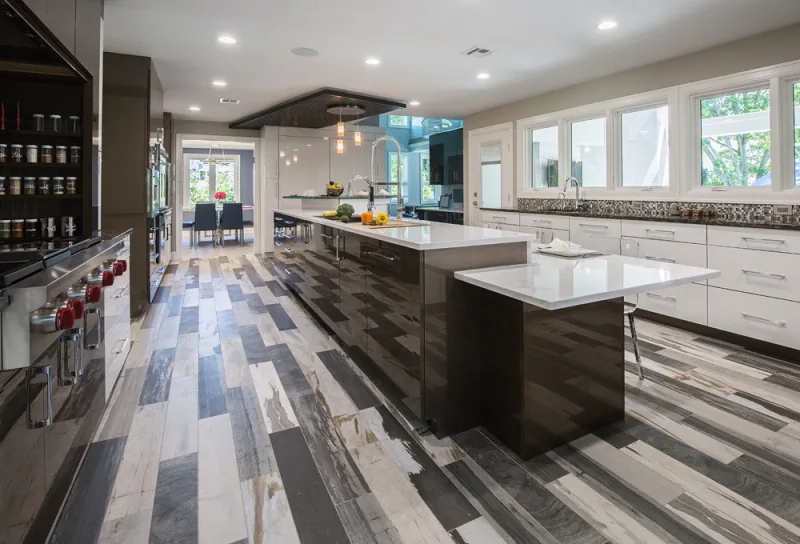 Dramatic kitchen with patterned porcelain floor and twin islands